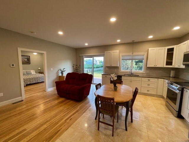 main living / kitchen area view toward outdoor slider/deck and bed room - 70 Bardwell St