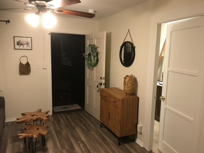 Living room area looking out the front door. Bathroom w/ washer dryer are through door to the R - 700 Earlham St