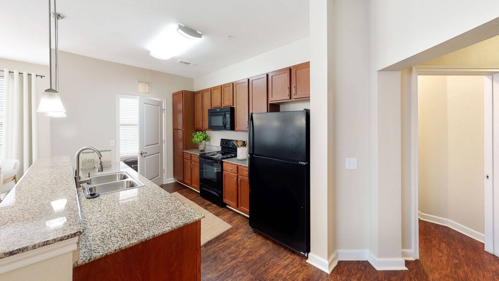 Kitchen Area with Black Appliances - Heritage Grand at Sienna Apartments