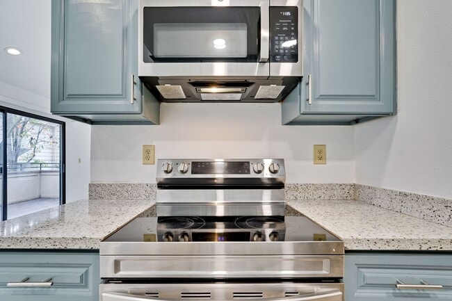 Building Photo - Spacious condo available in desirable Newpark Village community!