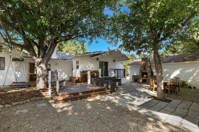 Shaded back yard with large deck, outdoor fireplace - 228 N Pueblo Ave