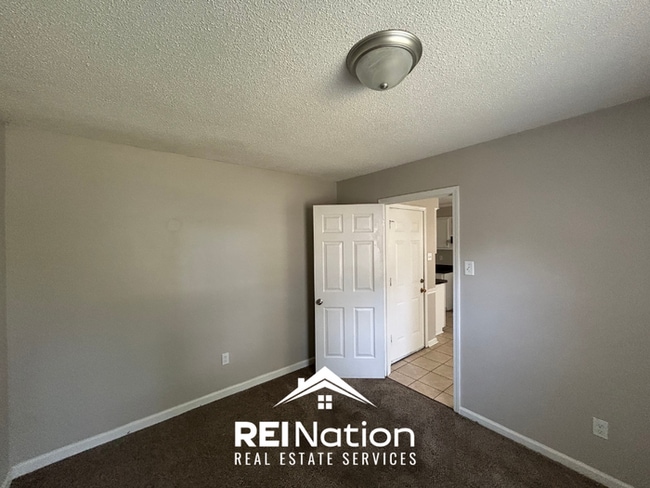 Building Photo - Spacious 4BR/2BA Near Southwind | High Ceilings, Brick Fireplace & 2-Car Garage