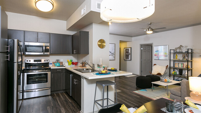 Apartment Kitchen with Stainless Steel Appliances, Dining and Living Room with wood floors. - Griffis Westminster Center