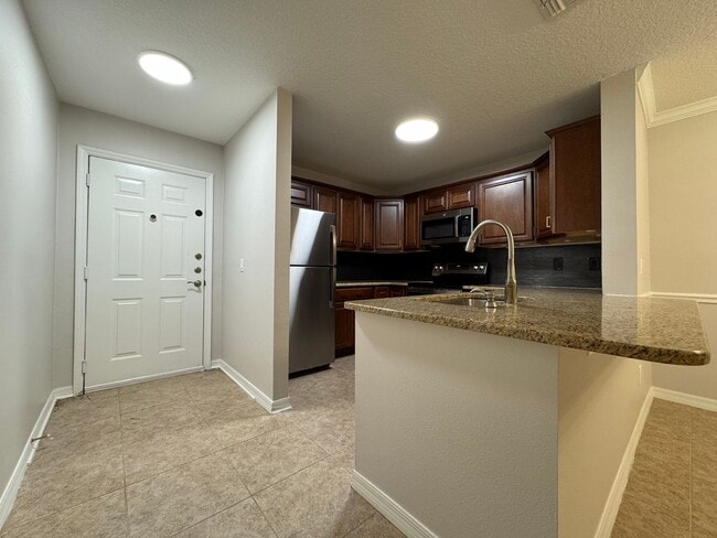 Building Photo - Oviedo 2/2 Condo with Tile & LVP Flooring, Updated Baths, New Paint & Appliances!
