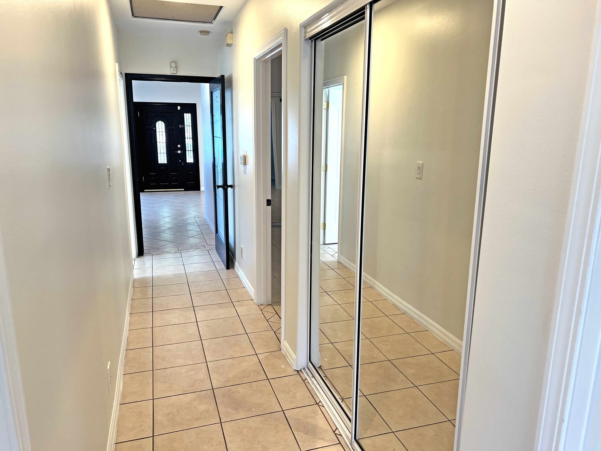 Hallway mirrored standard closet viewing back to main entrance. - 2330 S Mansfield Ave