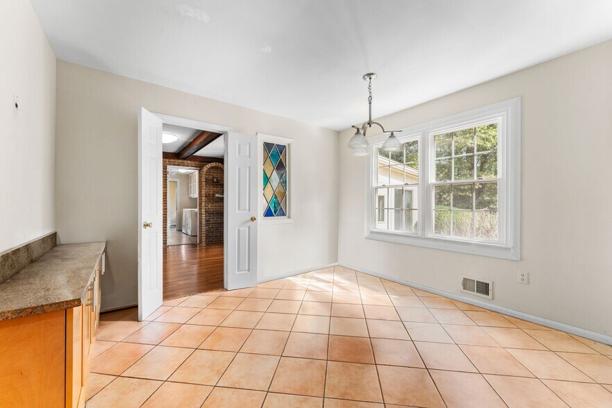 Large table-space kitchen area has panoramic views of rear yard! - 9 Snug Hill Ct