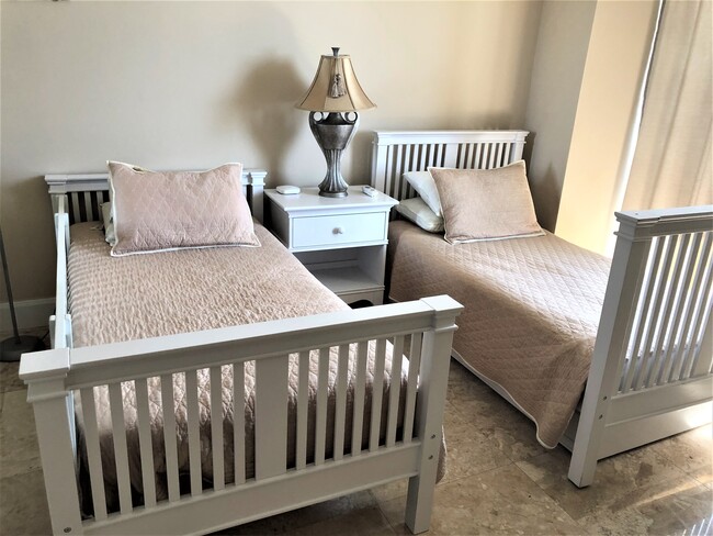 Second bedroom with two separate beds which can be converted into the bank bed. Baby crib available - 15901 Collins Ave