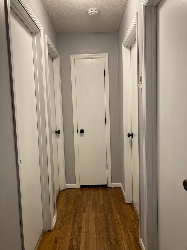 hallway leading to bedrooms and bathroom - 620 114th Ln NE