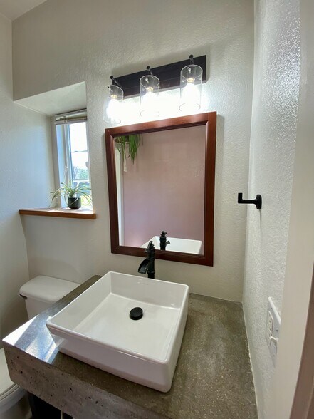 Updated sink with concrete counterop - 9056 Gale Blvd
