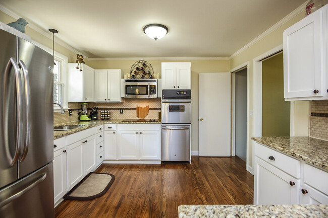 Photo 14. Kitchen with tiled back splash and granite countertops - 1623 Lethia Dr