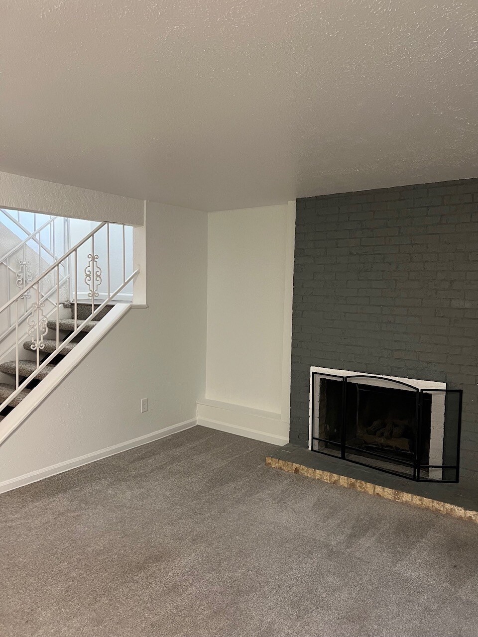 Large, open basement with fireplace. - 6396 E Mississippi Ave