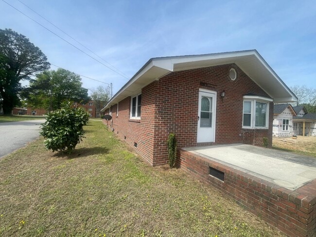 Building Photo - Brick Ranch- Dunn- 4 bedroom 2.5 bath- 2 car carport- Corner Lot
