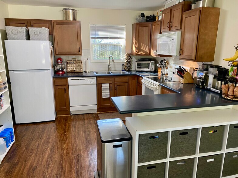 Kitchen with penninsula and solid surface countertops. - 16 Kyles Ln