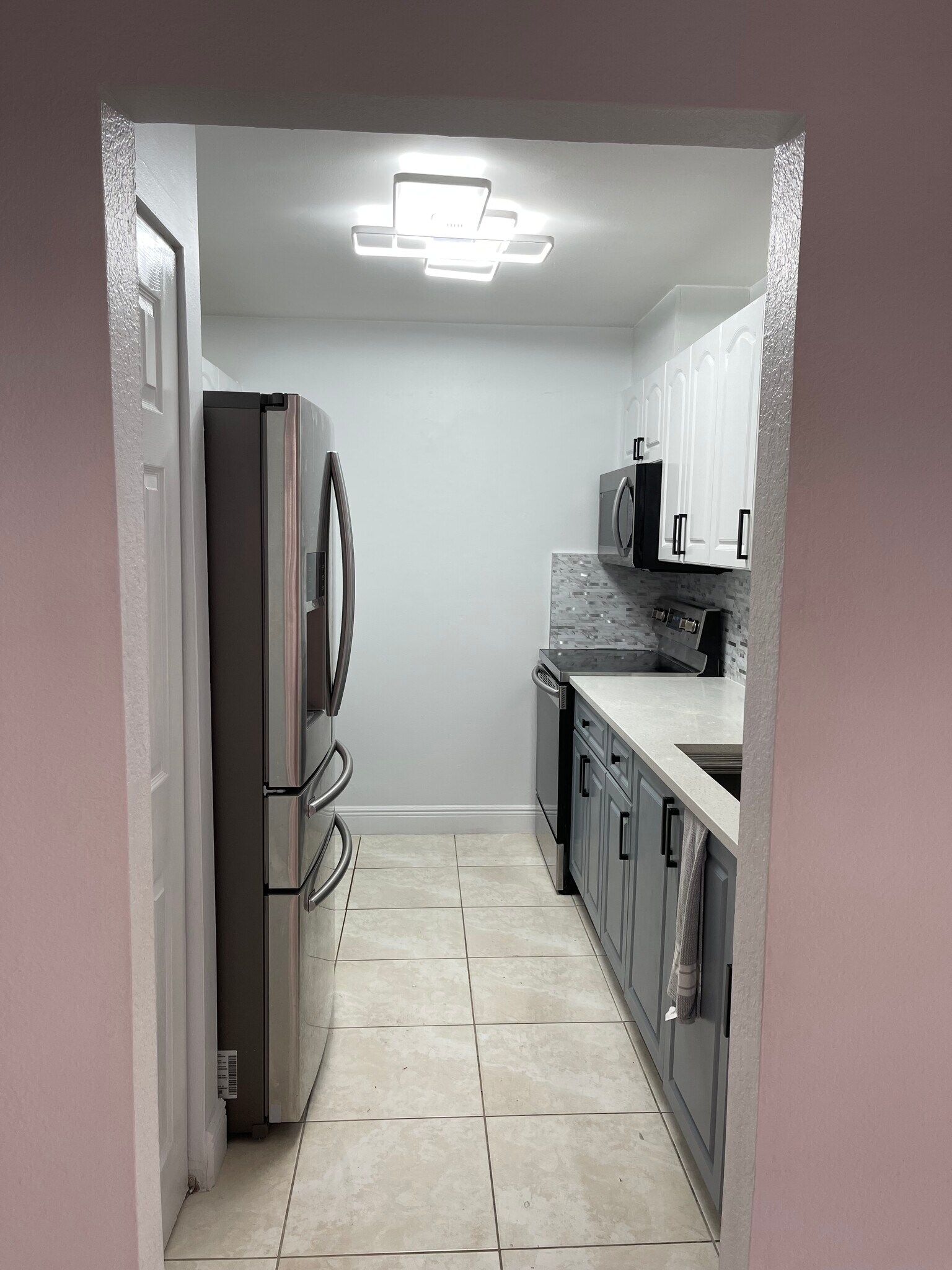The home is all white, the lighting is making the wall appear slightly pink. - 13909 SW 57th Ln