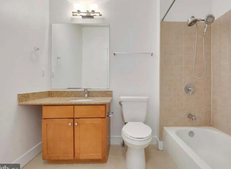The bathroom is roomy, includes a spacious countertop & 2 shower heads - 2910 Georgia Ave NW