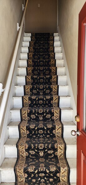 Stairs to unit 2 on Left - 210 S Logan St