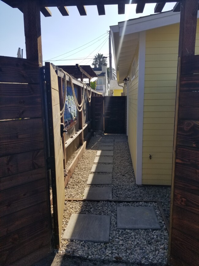 Gated entrance to front door and secondary gate for added storage area (ie. bikes, boards) - 6832 Zelzah Ave