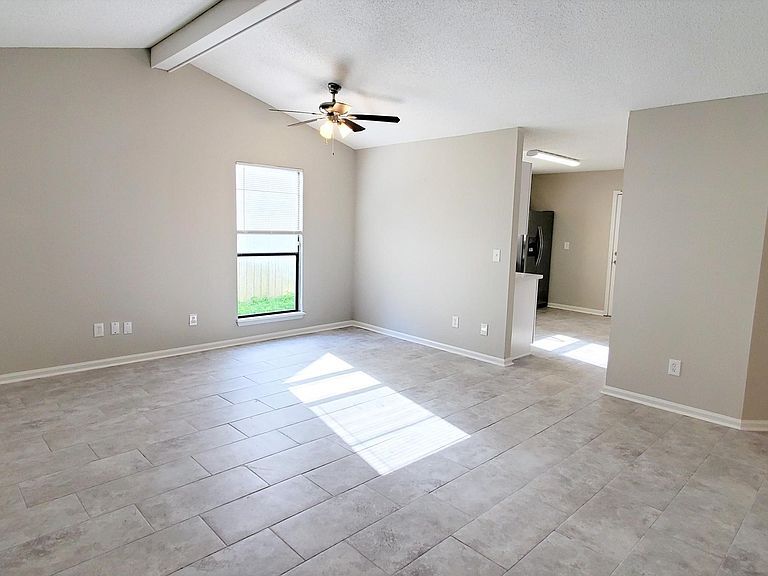 New installed 12" X 24" easy maintenance tile floor in common area with vaulted beamed ceiling and ceiling fan. - 1300 Bay Hill Blvd.