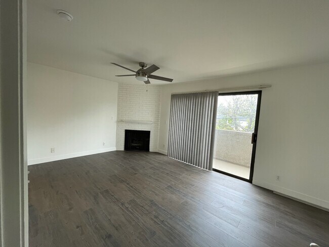 Main bedroom upstairs with gas fireplace, sliding door to balcony - 10330 Riverside Dr