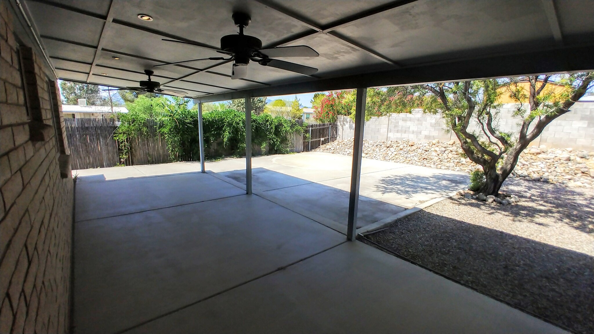 Large and spacious covered patio out back with dimmer lights and dual fans. - 539 Mallard Cir W