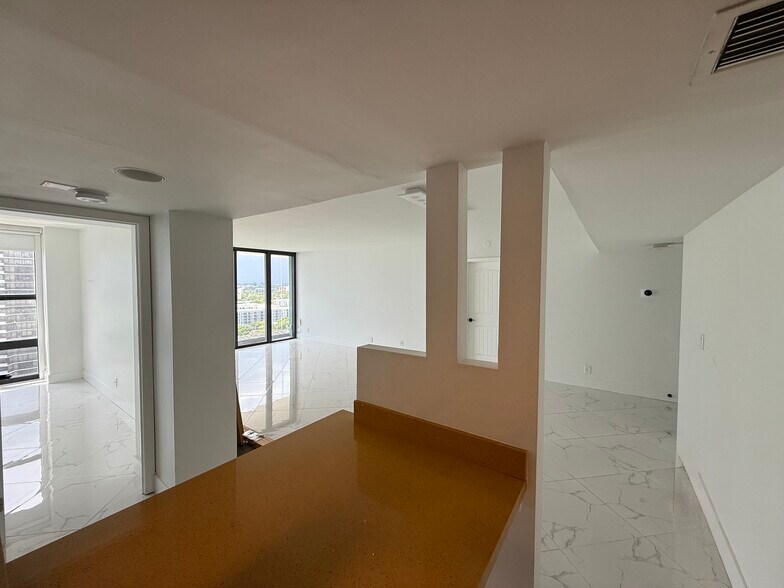 Open-concept KITCHEN flows seamlessly into social areas, great for hosting - 780 NE 69th St