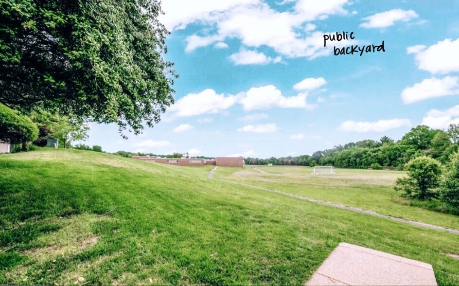 The field behind the home has a path to additional parking as well as a track for running. - 4767 Kandel Ct