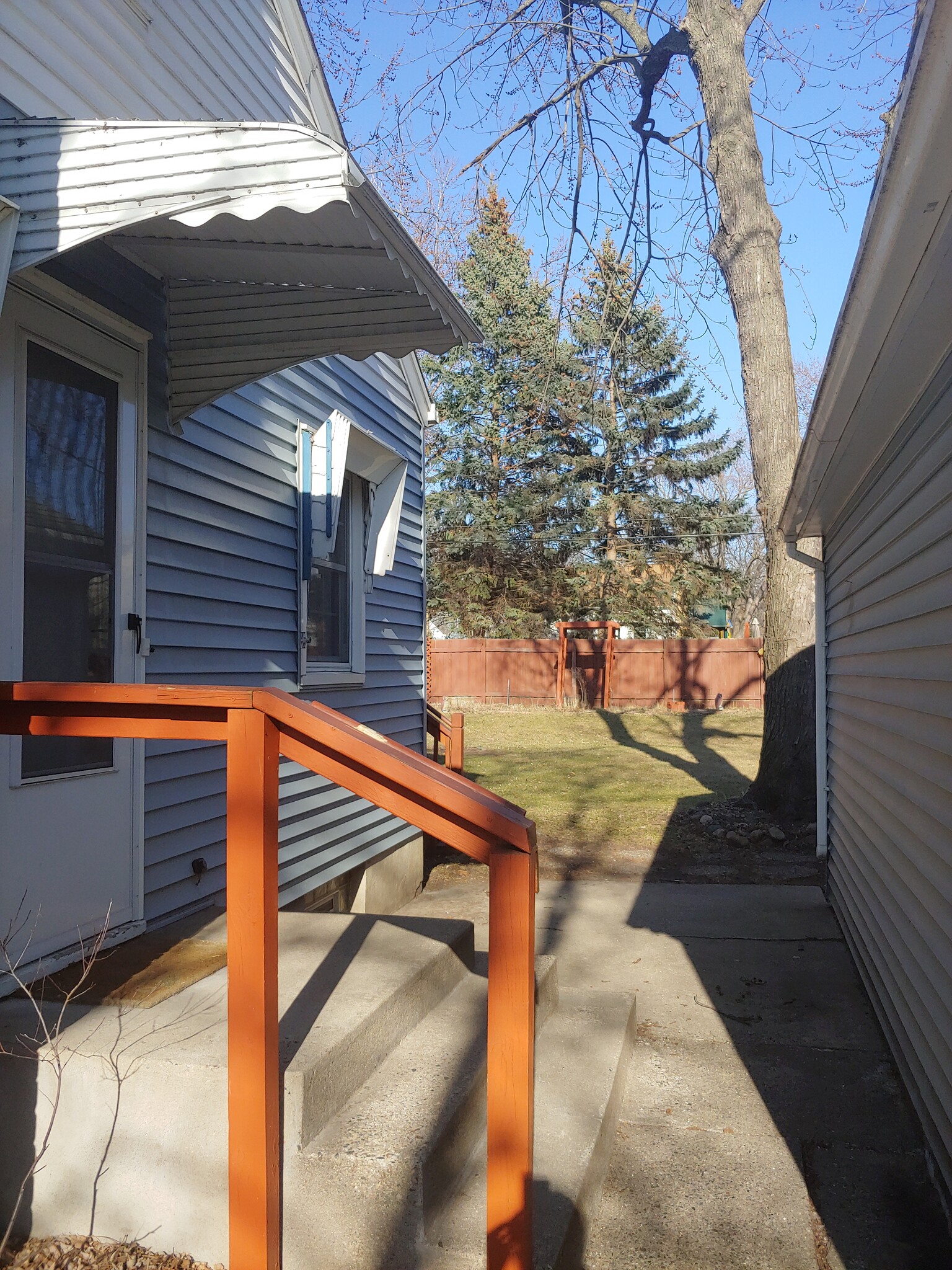 Walking between the house and garage to the backyard. - 7415 1st Ave S