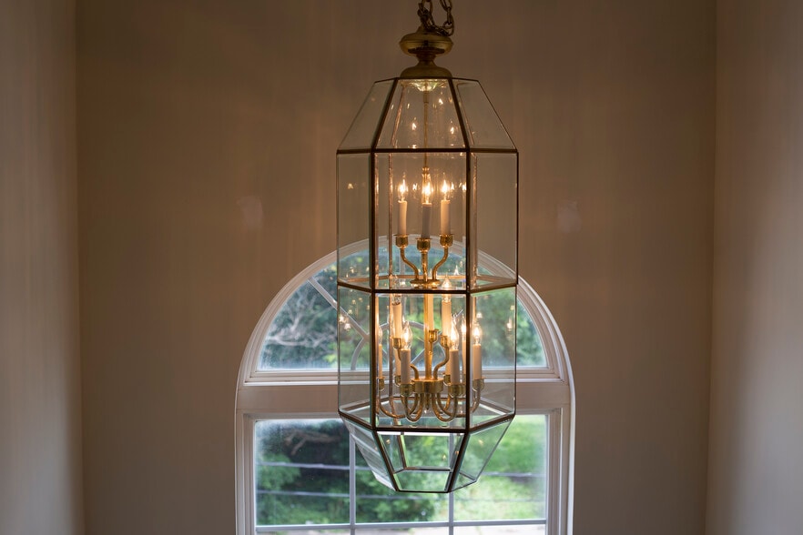 Stairs to 2nd floor with showcase window and lantern chandelier - 1008 Middletown Rd