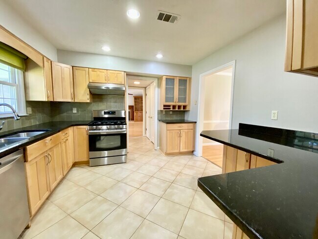View of kitchen hallway to the half bath and family romo. - 2160 Heritage Trace Ln