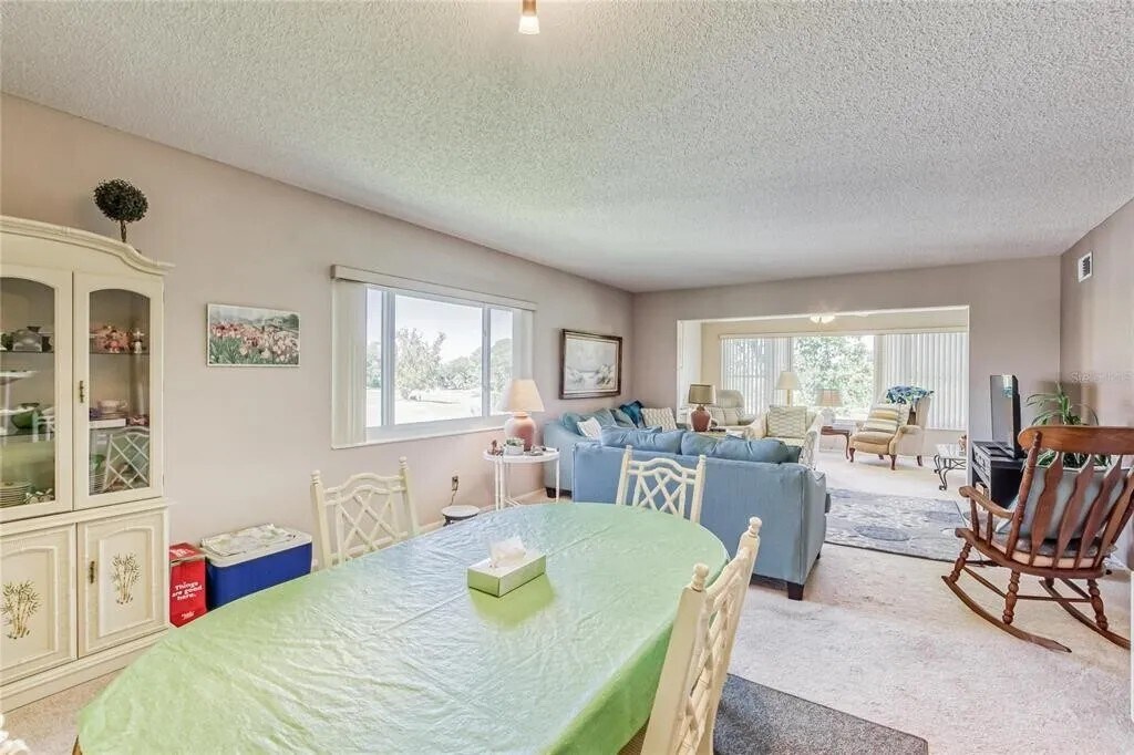 Dining area in the foreground; Living Room and Florida Room in the background. [Unit is unfurnished] - 2460 Franciscan Dr
