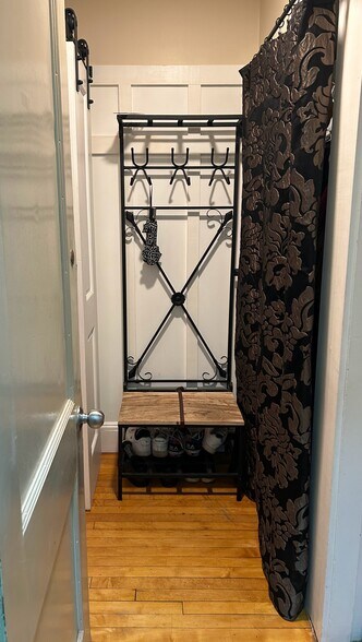 entry way with clothes rack behind the curtain - 127 White St