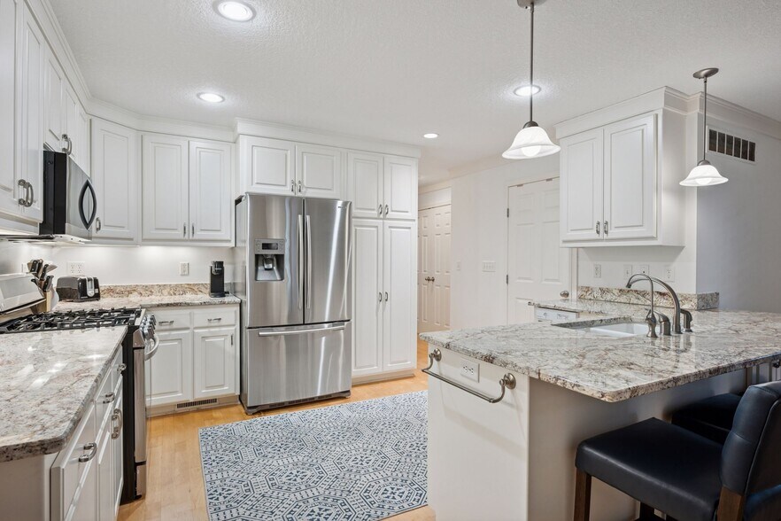 Bright and white kitchen with plenty of storage space - 145 Holly Ln N