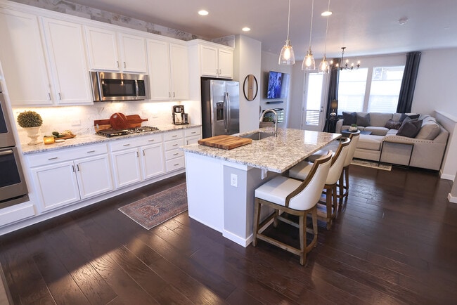 Main level kitchen and living room with access to balcony. - 15637 E Broncos Pl