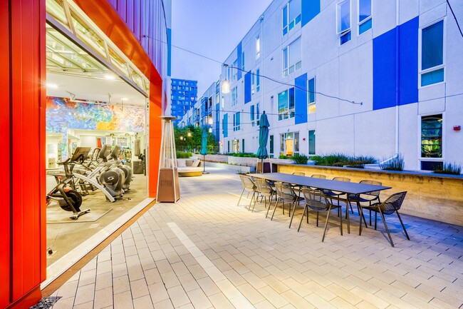 The fitness center garage doors open up to the courtyard for fresh air - Mission Bay by Windsor