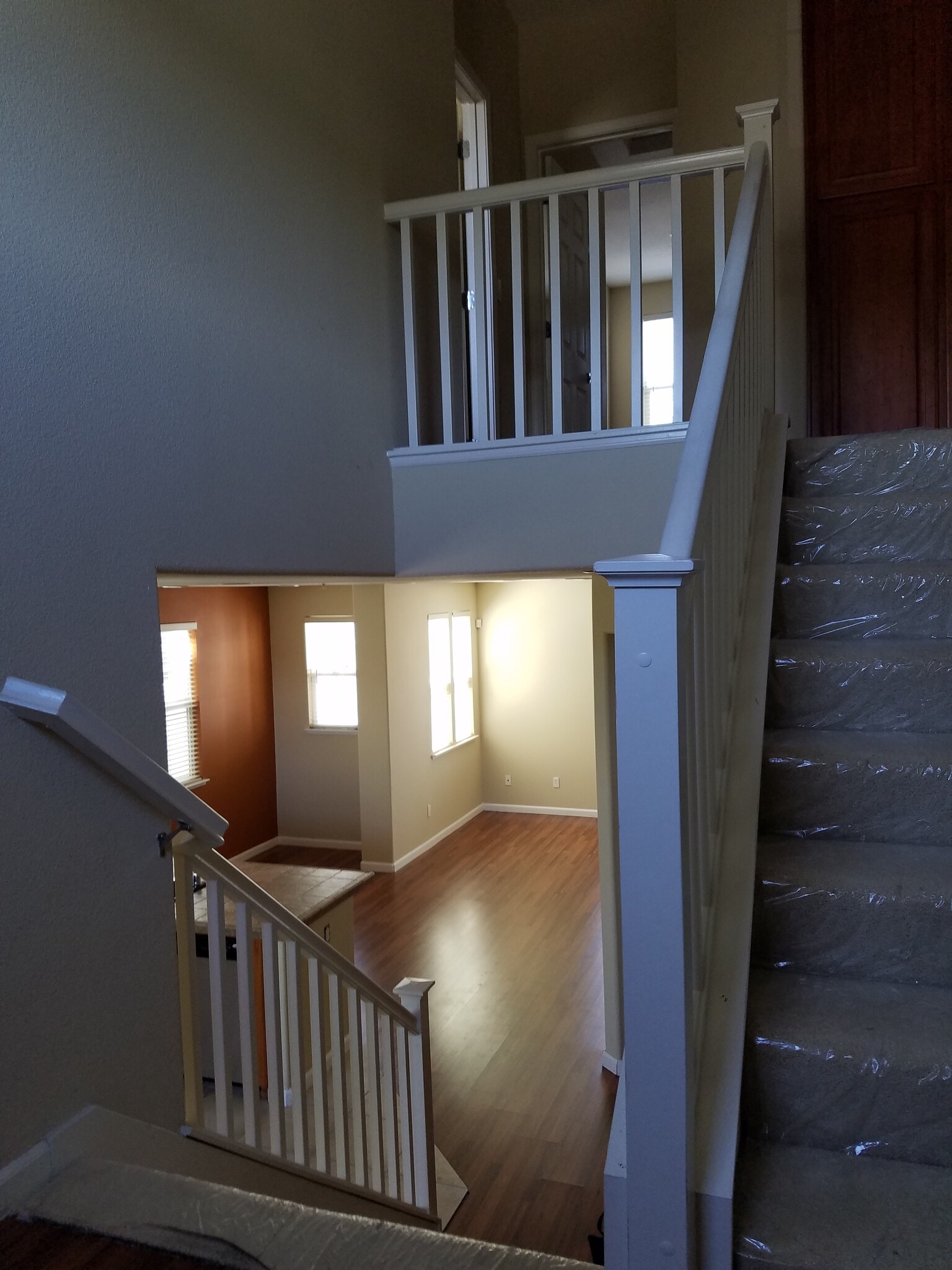 A three story house with a wide stair case and sturdy railing. - 2878 Hilltop Mall Road