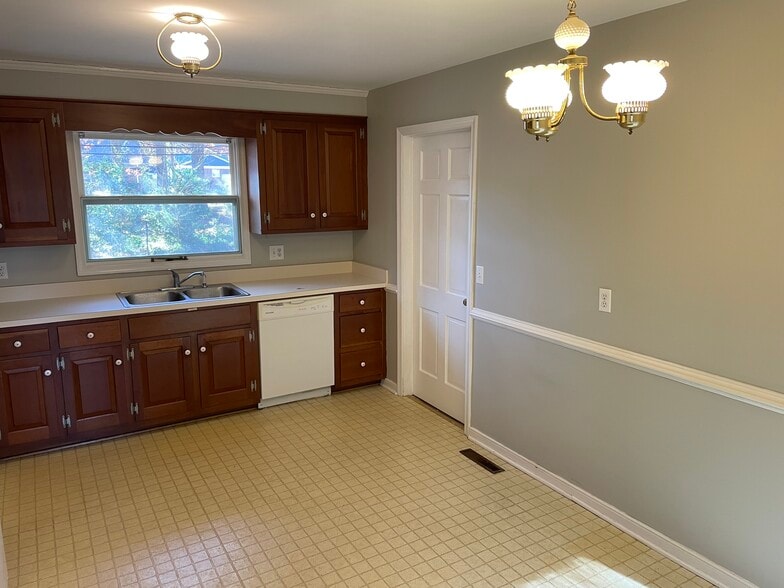 Kitchen w/ utility/laundry through doorway - 202 Norwood Dr