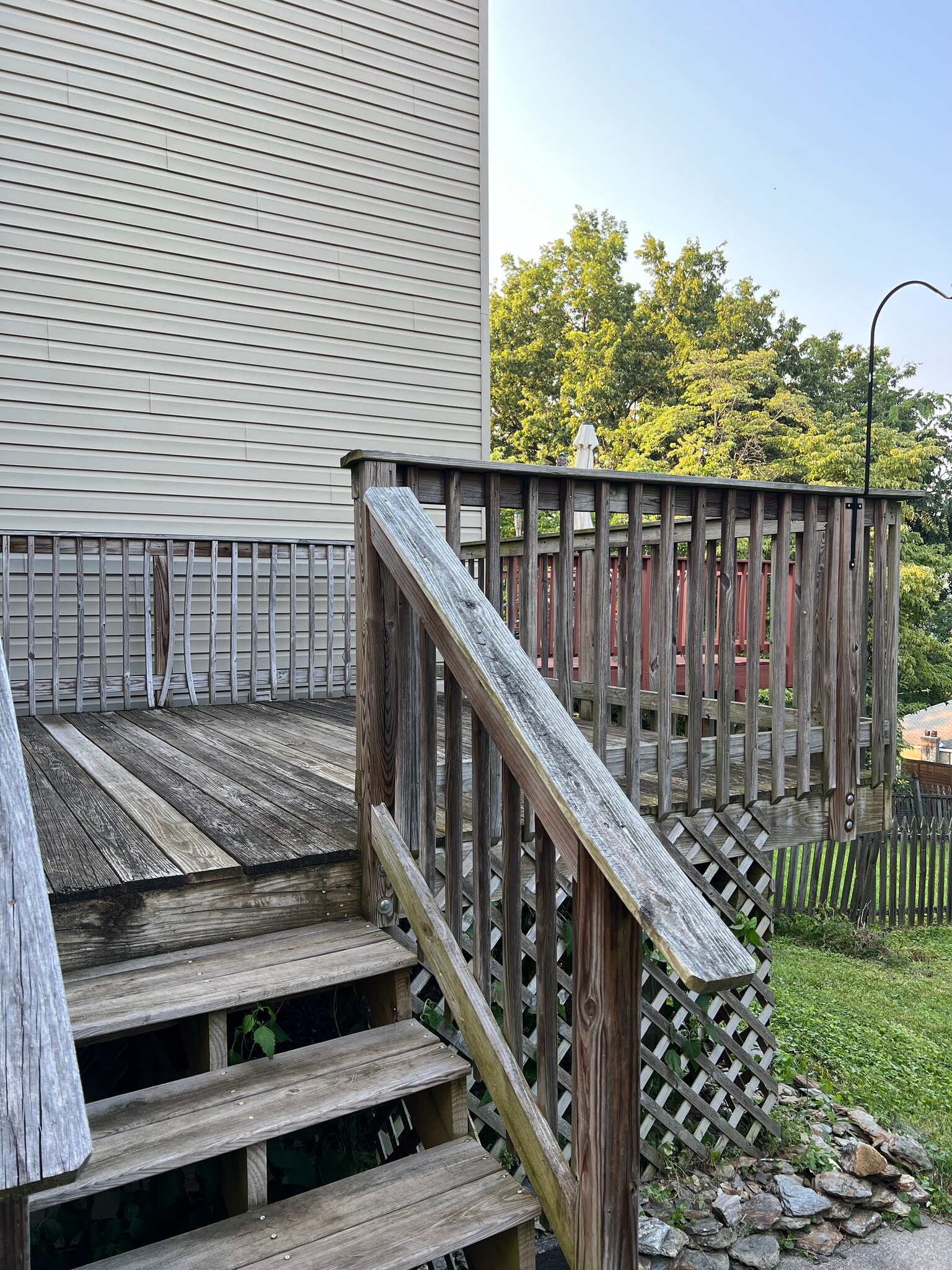 Deck stairs connect to the sidewalk from the front gate and open out into the yard. - 126 Merion Ave