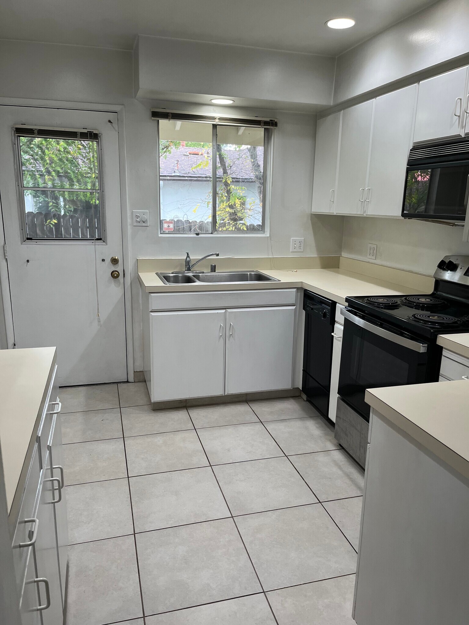 Kitchen has Refrig, strove, microwave and disposal. Back Door to yard and secured garage access - 513 28th St