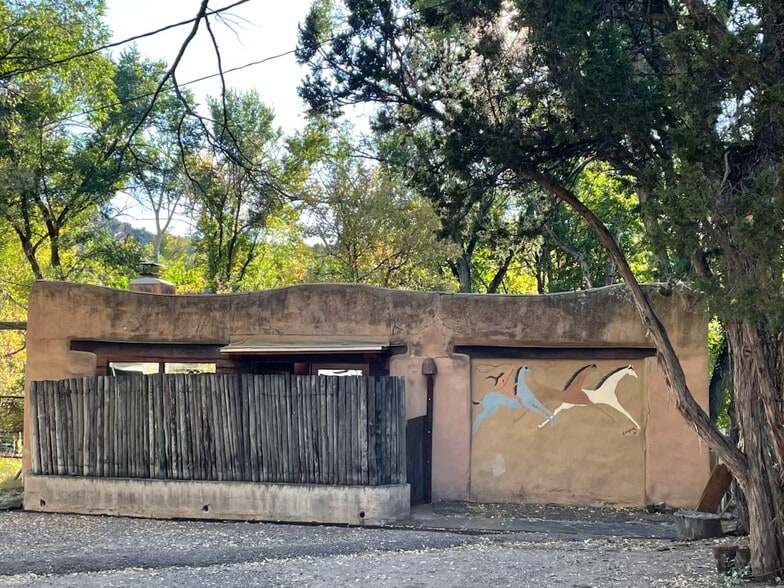 Front of casita with parking area and 1970's mural - 1470B Bishops Lodge Rd