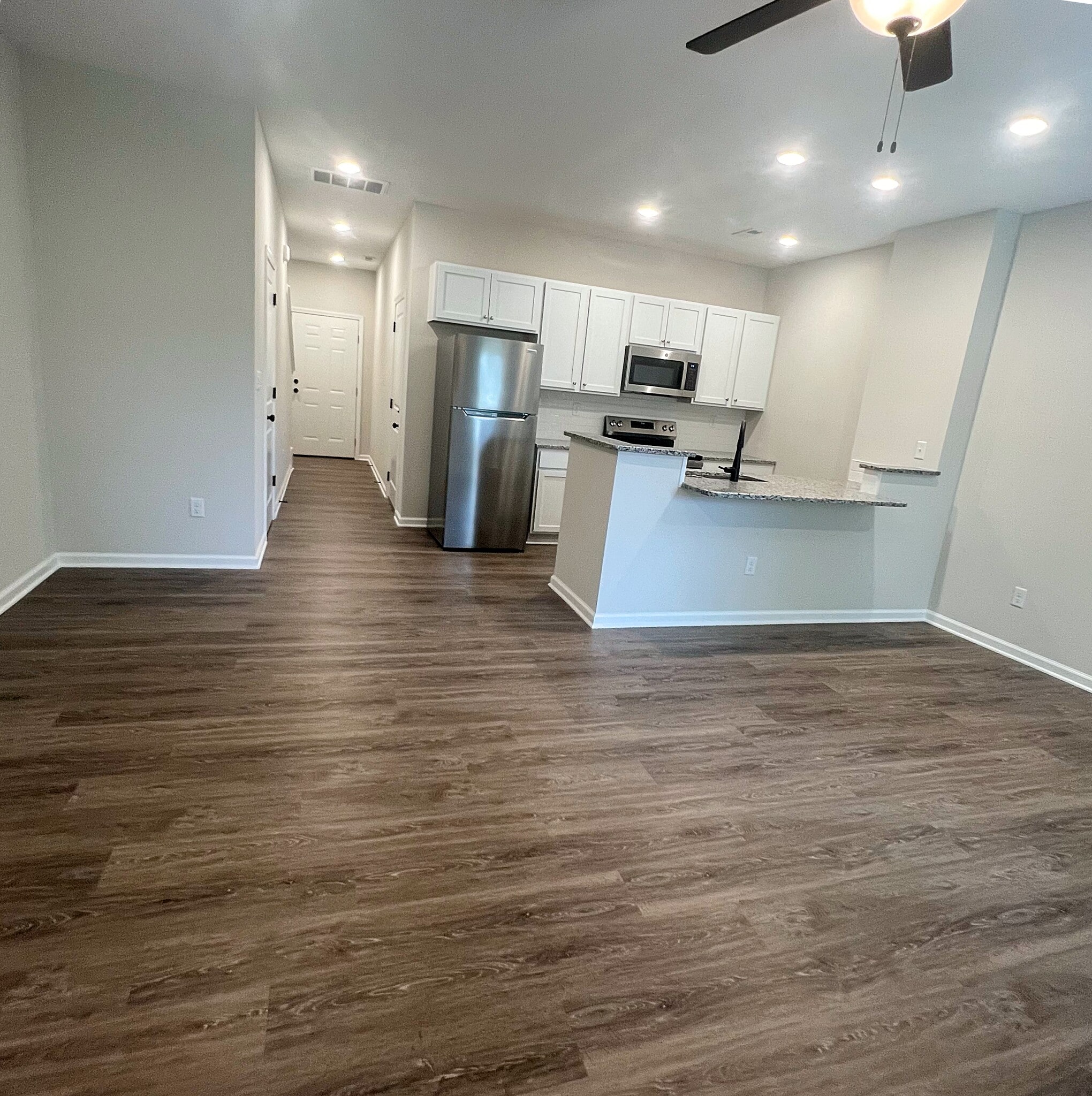 Brand-new stainless appliances with plenty of room for a dining table—perfect for late-night study - 205 Cherry Way