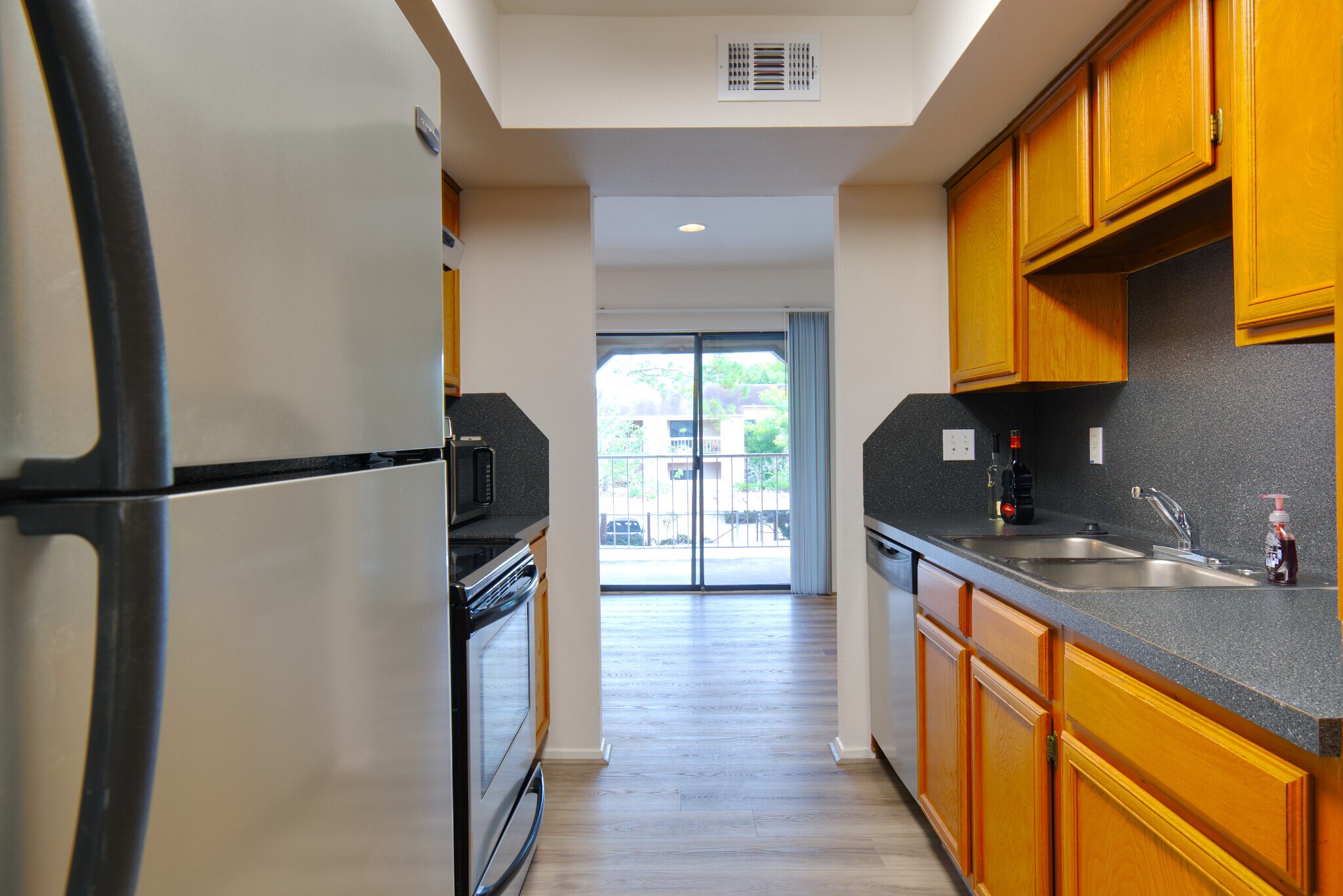 View of the kitchen, including the fridge. - 2025 Augusta Dr