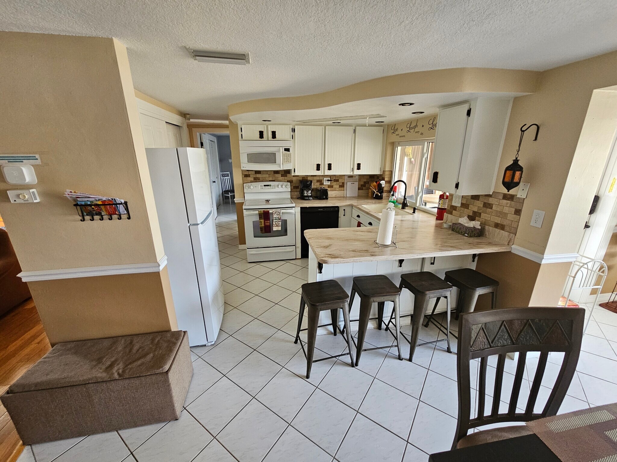 Kitchen area with 4 seating bar area. Canal water view!!! - 3931 Sail Dr