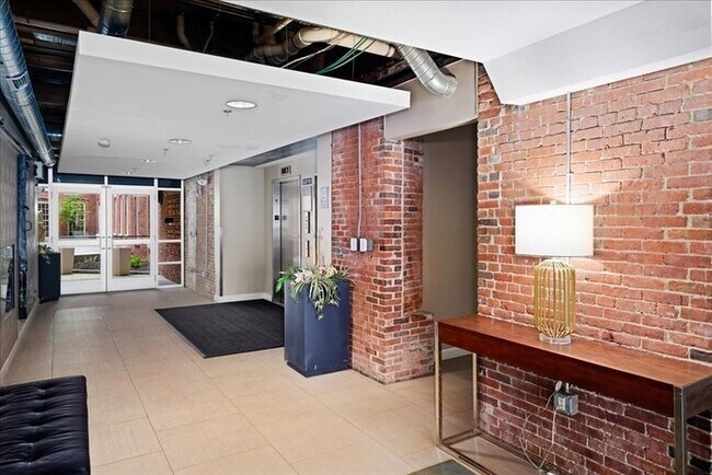 Building Photo - Stylish Industrial Loft with Exposed Brick, High Ceilings & Modern Kitchen