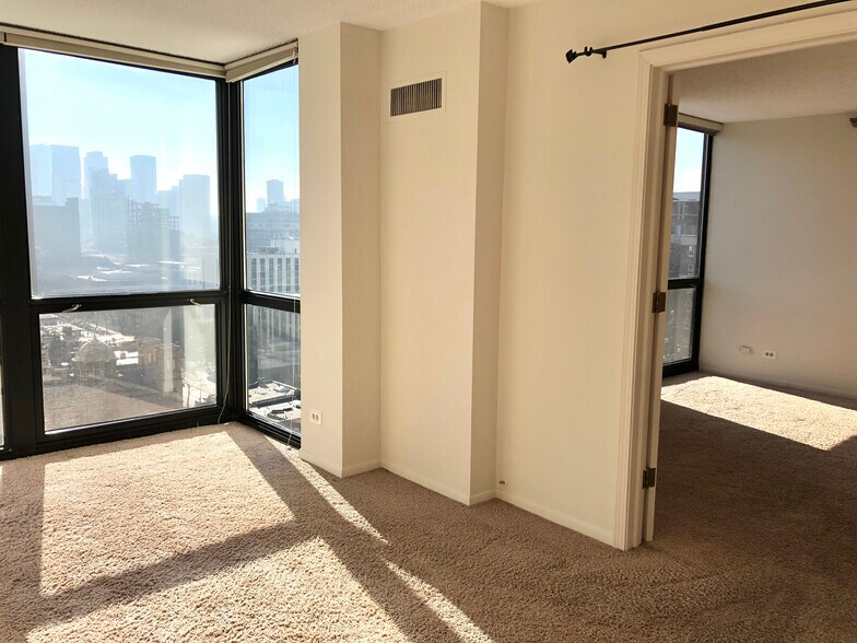 Bedroom with view into the living room. - 1122 N Clark St