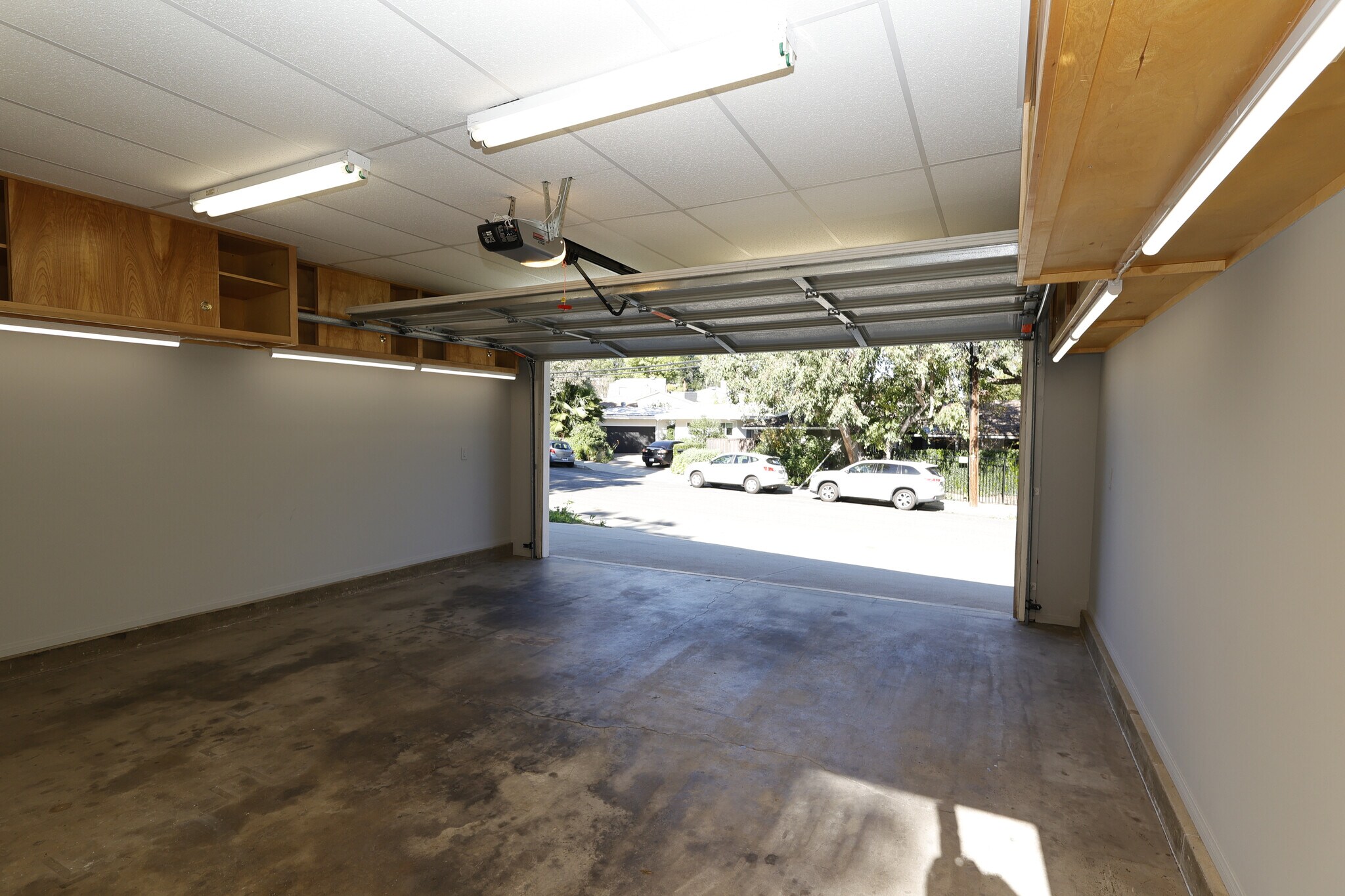 Retractable garage door opens to two additional uncovered parking spaces outside - 4831 Canoga Ave