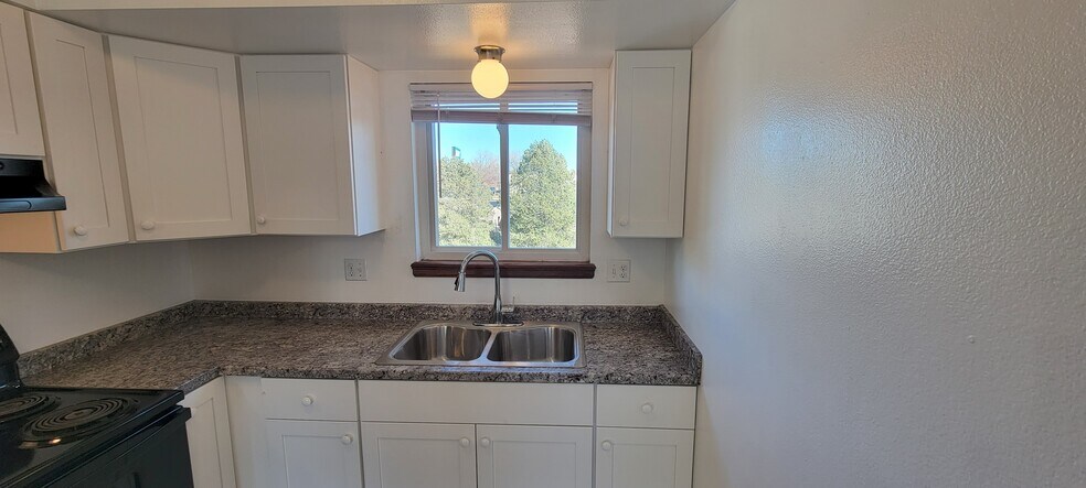NEW counter tops, sink and faucet. Nice view out the back. - 6646 Provincial Dr