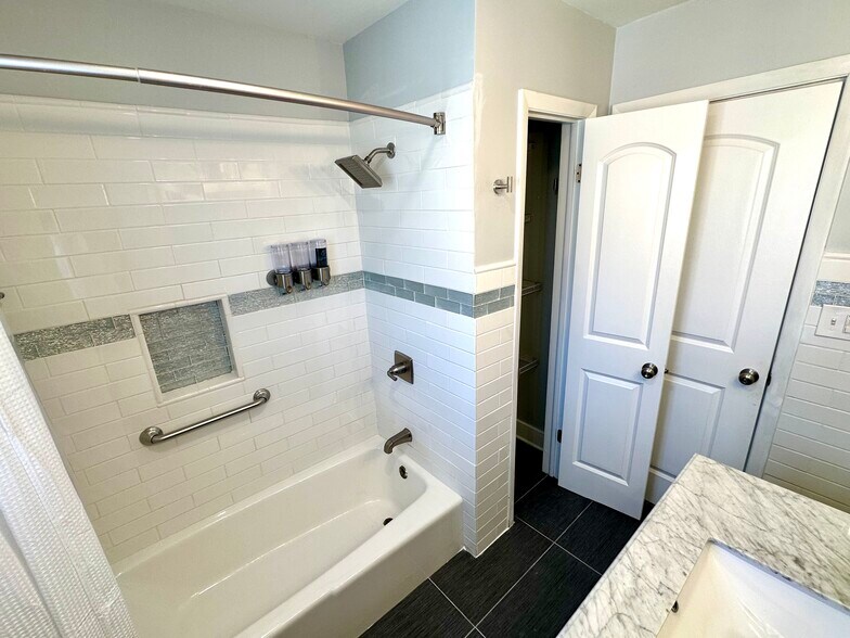 Fully redone bathroom with linen closet. All new tiling. - 671 56th St