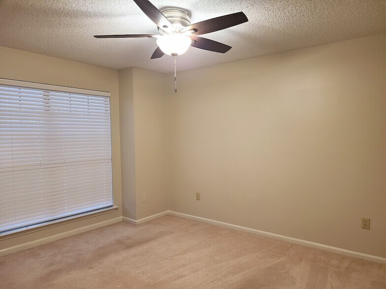 Guest bedroom #1 with window overlooking private patio - 12439 Coursey Blvd