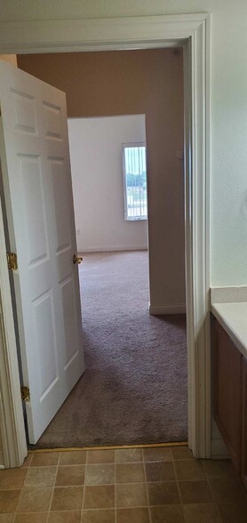 Bathroom to walk in closet - Uptown Brass Apartments