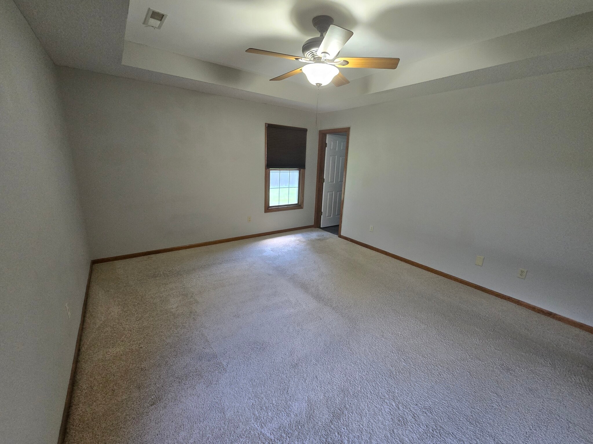 Primary bedroom with tray ceiling view - 3700 Falmouth Dr